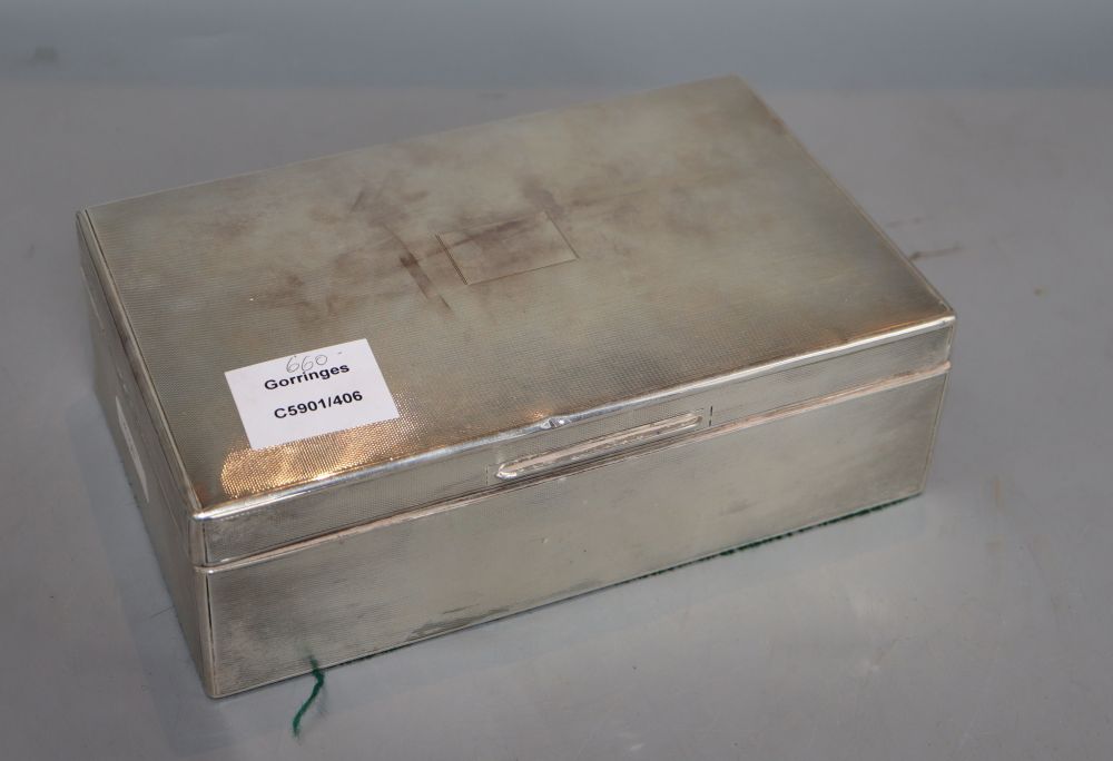 A 1930s engine turned silver rectangular cigarette box, William Comyns & Sons Ltd, London, 1936, 22.9cm, gross 35 oz.